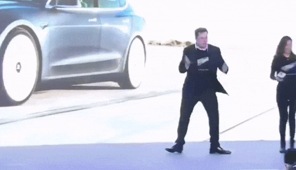 gif-elon-musk-dancing-on-stage-with-woman-hands-microphone.gif