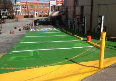 Green-electric-vehicle-EV-car-charging-station-parking-lot-concrete-overlay-coating-yellow-line-.JPG