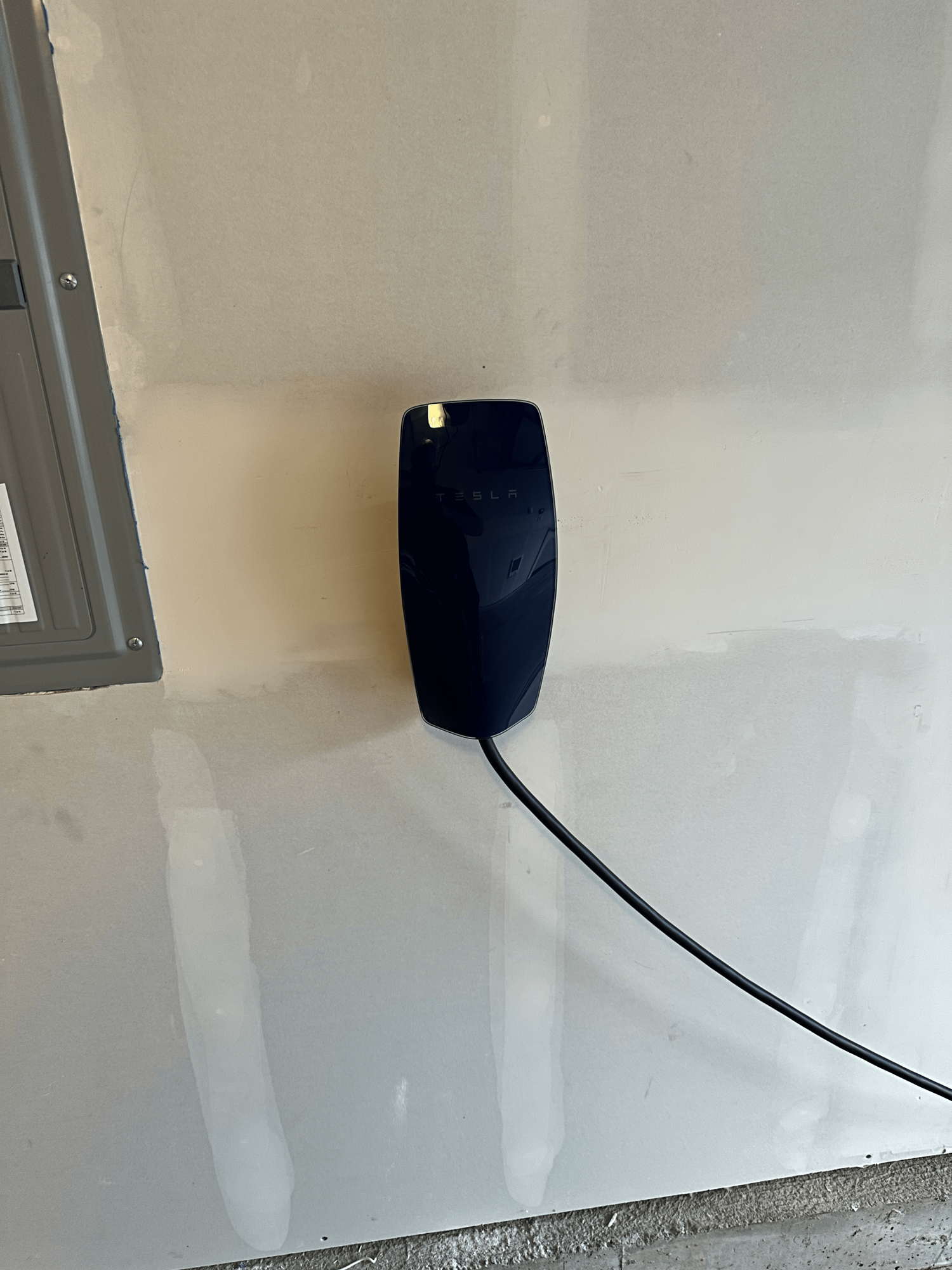 Tesla Wall charger mounted on wall.