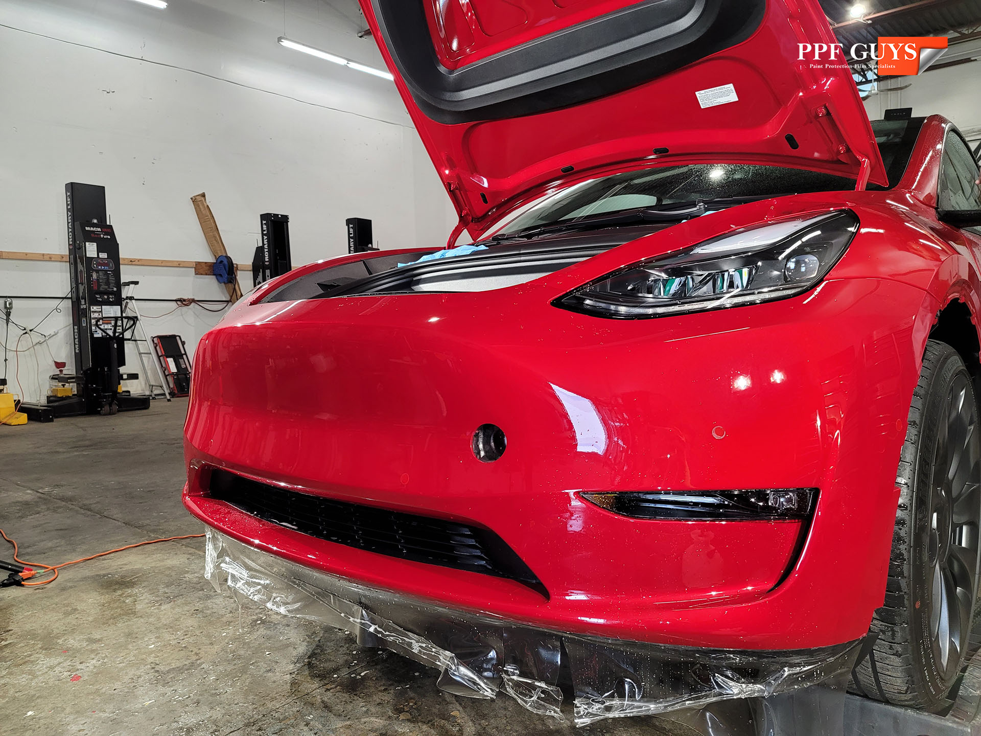 ppf guys model y red front end ppf and ceramic coating (2).jpg