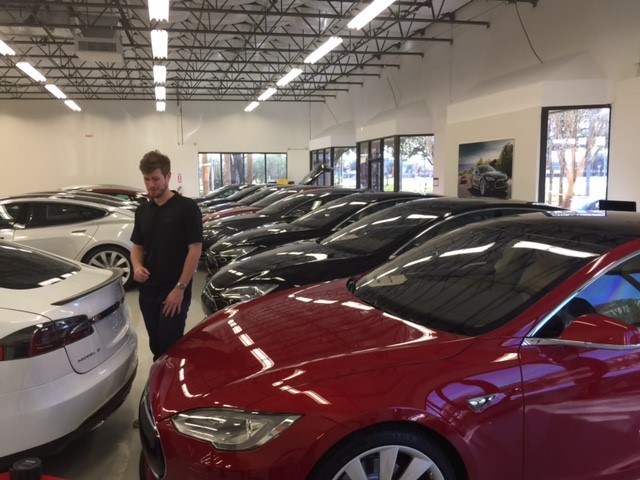 Teslas stacked up in showroom.jpg